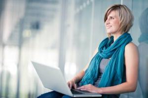 pretty young female student with a laptop computer