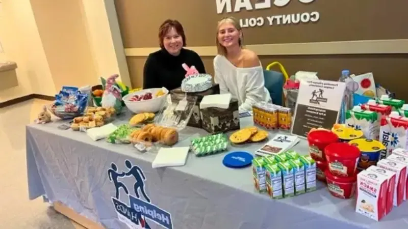 Two women at Helping Hands table