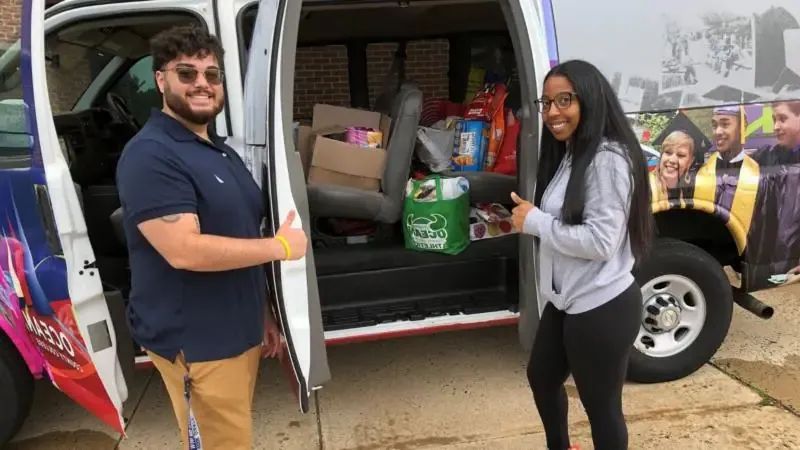 Two people unloading truck